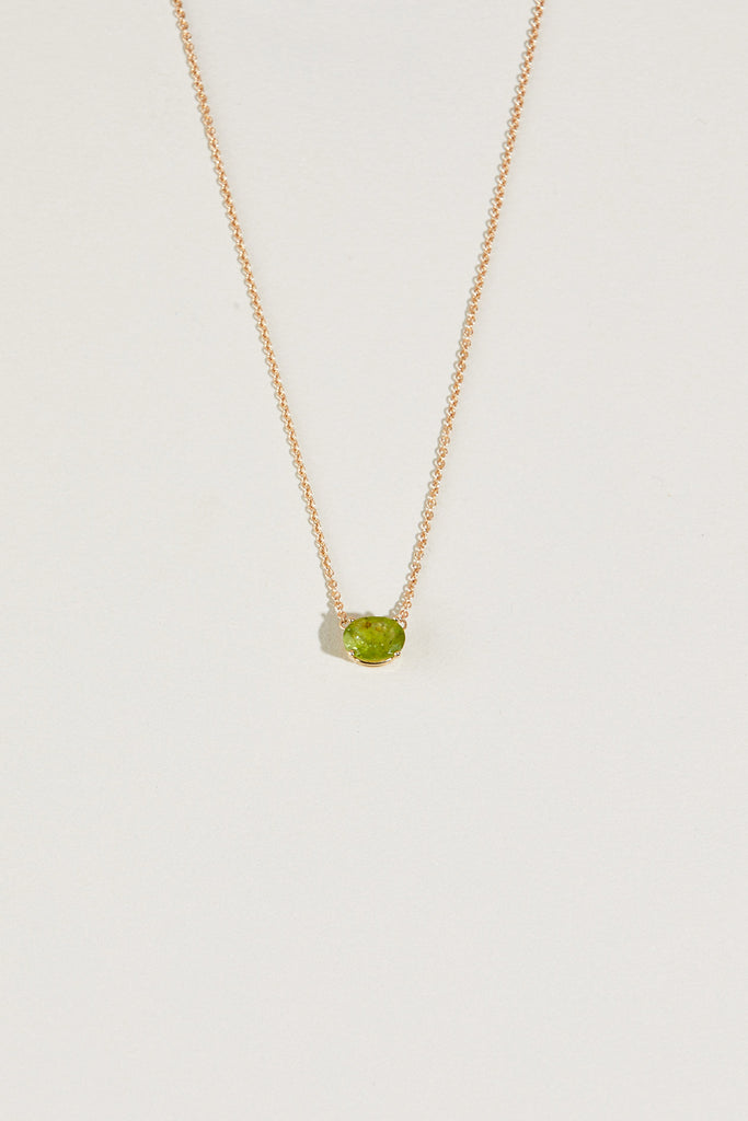 gold necklace with oval peridot