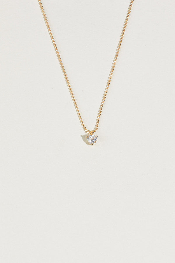 close up of gold ball chain necklace with white sapphire trillion